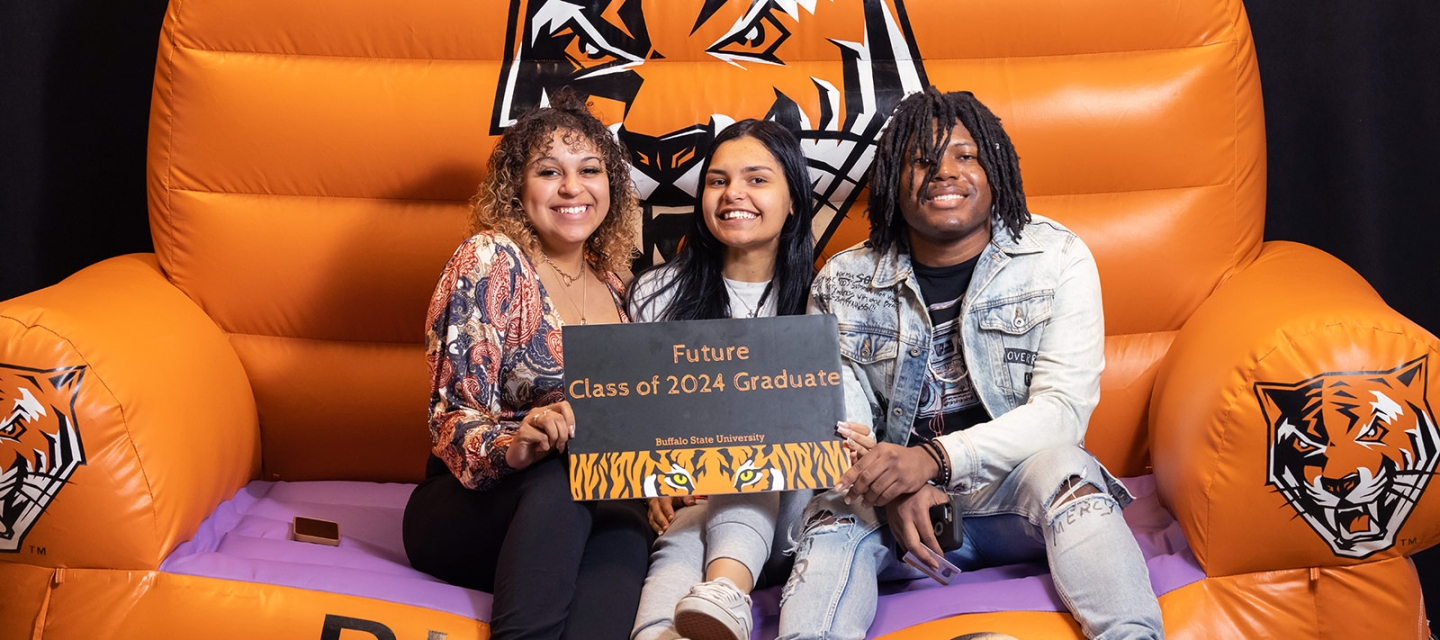 2024 students sitting in a giant chair